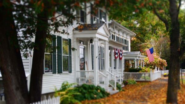 White house in fall flying American flag