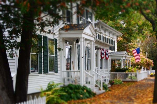 White house in fall flying American flag