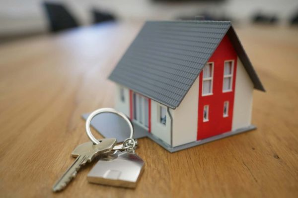 Toy house with keys on desk