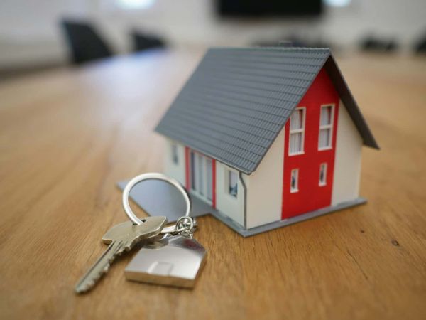 Toy house with keys on desk